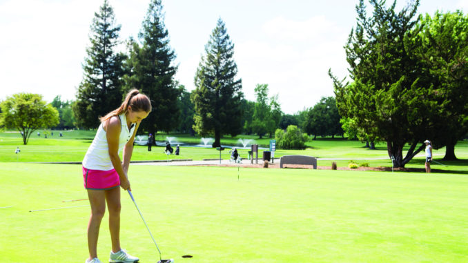 Sophomore Katie Dunaway prepares for a putt during an afternoon practice on Monday, April 11.
