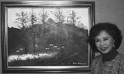 Image: Sac State alumnus displays paintings at art exhibit:Sac State alumnus and former Secretary of State March Fong Eu stands in front of one of her paintings of the Kweilin mountains.: