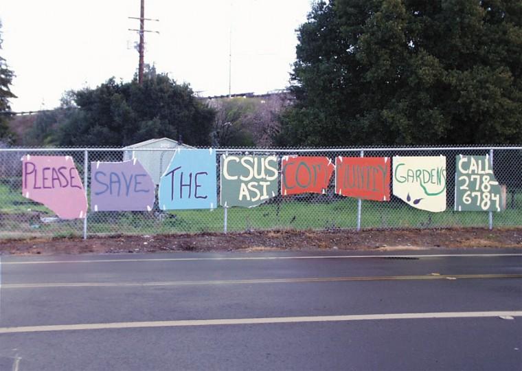 Image: ASI garden remains open for semester:Community garden members try to gain student support through these signs on State University Drive East near the Folsom Blvd. entrance to campus.(Photo: Christy Boyle/ State Hornet):