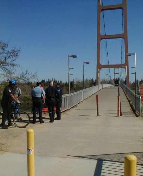 Image: Bicycle and vehicle collide at bridge:Police gather at Guy West bridge ramp after today's accident.: