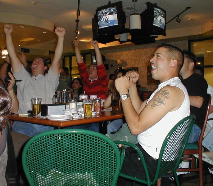 Image: Kings? playoffs, pizza, and beer:Caption: Luis Munoz, Julio Tamallio and Marcos Torrez (left to right), enjoy game four of the Kings-Suns series. Round Table accomodated 115 students, who chose to root for the Kings on campus. (Photo by Andrew N. Duong/ State Hornet):
