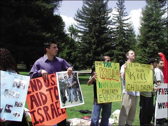 Image: Students argue both sides of Mid East conflict:Pro-Palestinian students in the Quad hold up signs protesting U.S. policies. Photo by Natalie Morris/State Hornet: