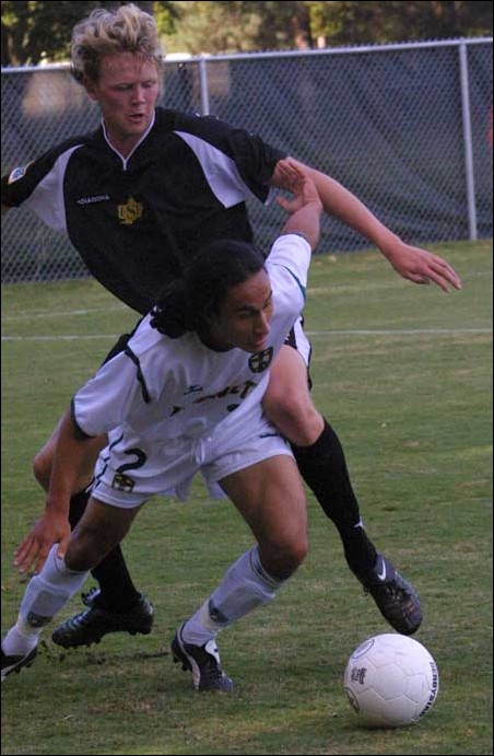 Image: McDougall blanks USF, Hornets snap winless streak:Justin Ancheta battles with a USF player for a loose ball.: