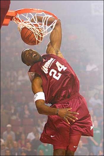 Image: Who is the Greatest Dunker of All Time?:Jameel Pugh stuffs half of his arm in the rim at a University of Massachusetts Midnight Madness.Photo Courtesy of Associated Press: