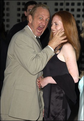 Image: Threes not a crowd, its a bloodfest!:Courtesy of WireImage.com Robert Englund gets friendly with a pretty gal at the premiere of Freddy vs. Jason: