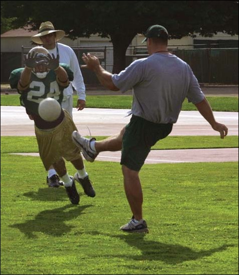Image: New coaches change old ways:Kevin Tennerson, practicing his punt blocking skils with special teams assistant coach Jeff shuman, will be competing for a starting safety position after redshirting last year.Photo by Nick SchillerState Hornet: