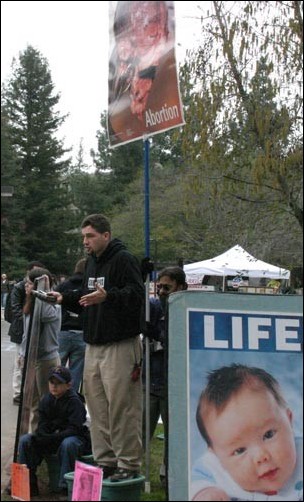 Image: Abortion rally upsets students:Jason Storm, one of the speakers of the Survivors of the Abortion Holocaust group, debates religion with Sacramento State students in the Library Quad on Jan. 26. Kathy Bustillo/State Hornet: