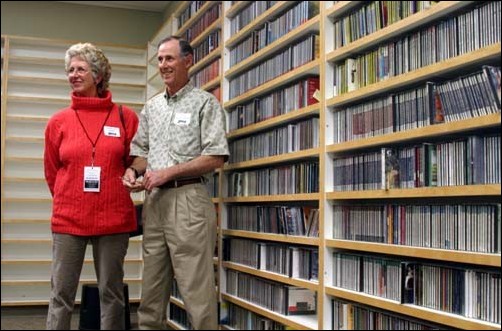 Image: Students crash radio stations private party:Julianne Rigali and Tom Barrett-Smith, listeners of Capital Public Radio, listen to how the playlists are prepared on a tour in the music library which has walls covered with CD collections on Thursday, April 22 2004. Jolana Howard/State Hornet: