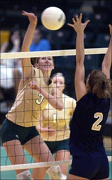 Image: Hubbard and Wilson power Hornets past Montana State:Sacramento State sophomore outside hitter Atlee Hubbard spikes the ball past Montana State senior LeAnn Kinvig to give the Hornets a 30-28 win in game three Saturday, Oct. 30, 2004 in the Hornets Nest. Sac State went on to win the match 3-1, marking the :