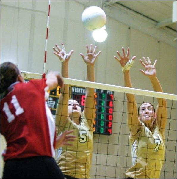 Image: Hornet reserves spot at the top:Stephanie Gamst (left) and Shannon Arts (right) attempt a block of Eastern Washingtons Lizzy Mellor (No. 11). Gamst was named Big Sky Player of the Week for the first time in her career after averaging 13 assists and hitting .400 over the weekend, leadin: