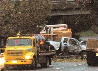 Image: J Street accident kills woman:Workers remove a tree from a truck involved in an accident at the J Street underpass. Ken Larmon/State Hornet:
