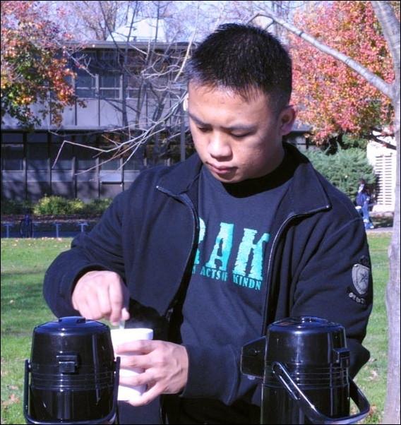 Image: Green Sting begins philanthropy:Edmar Cimatu pours hot cocoa in the library quad Monday in exchange for a donation to a local animal shelter. Cimatu is volunteering for Random Acts of Kindness which is hosting canned food and toy drives. Andrew Nixon/State Hornet: