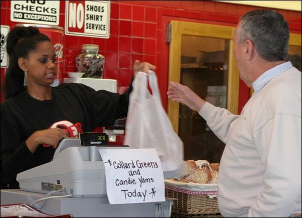 Image: History of great taste:Siera Corbett gives a take-out order to Tim Marling at Everett and Jones Barbecue on Franklin Boulevard.:Rebecca Adler/State Hornet