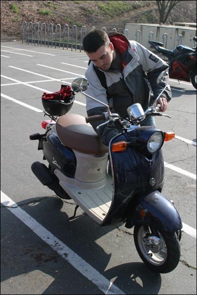 Image: Two-wheel advantage:Junior Denton Ward prepares to ride his Vespa out of the parking lot adjacent to the Hornet Bookstore.:Tojo Adrianarow/State Hornet