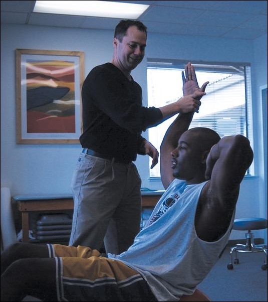 Image: Pugh Ready For Prime Time:Jameel Pugh, with his physical therapist Greg Parry, rehabs his ailing abdomen and lower back last week. Pugh has two sets of dunks, depending on his back pain level.Photo by Jamie Gonzales/State Hornet: