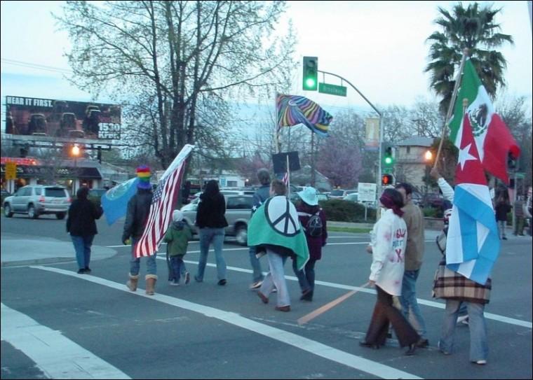 Image: Sac state student, professor call for peace:Protestors wave flags of countries that the U.S. has demonized, according to an anti-war protestor.Photo by Max PuckettState Hornet: