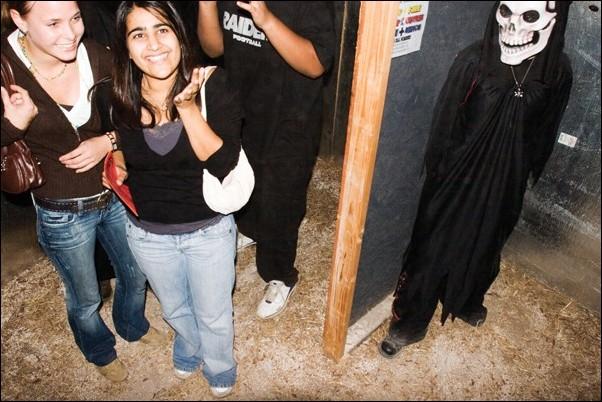 Image: Scream at ghouls, not your empty wallet:Inga Bliddal (left) and Kiran Athwal (right), two students in the Global Education Program at Sac State from Germany and England, walk casually through a haunted house unaware of the ghoul waiting to jump out of the darkness at Scream Extreme, a haunted h: