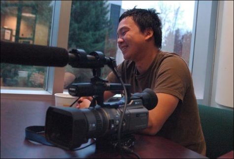 Image: Hmong culture through the power of film:Paul Lee Cha, the president of the Hmong University Student Association and a graduate student in the self-created major of Hmong Studies, sits with his camera as he discusses his short film ?The Hmong Journey.? Cha hopes to eventually join the Peace Corp: