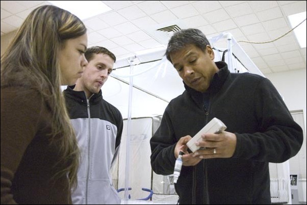 Image: Viagra: Better performance up high?:Roberto Quintana, assistant professor of kinesiology, explains to graduate student Irene Cisneros how to use a machine that will be used in a Viagra study.Photo by Shane Angell/The State Hornet: