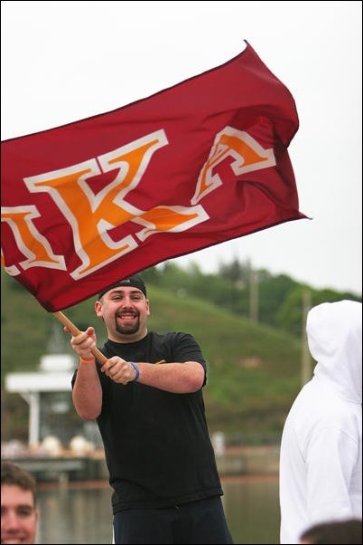 Image: Smaller events center debated:Nick Portoff waves his Pi Kappa Alpha flag at the aquatic center during Sundays Greek Week events.Photo by Andrew Nixon/State Hornet: