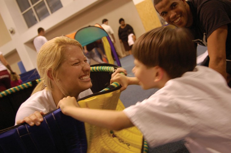 Top: Kelly Peck, a graduate student in early childhood special education, plays with Austin on March 6 in Solano Hall.: