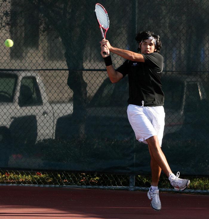 Mens No. 1 Xavier Barajas-Smith nails a backhand against Saint Marys on Saturday. He won his singles match 7-6, 6-2.: