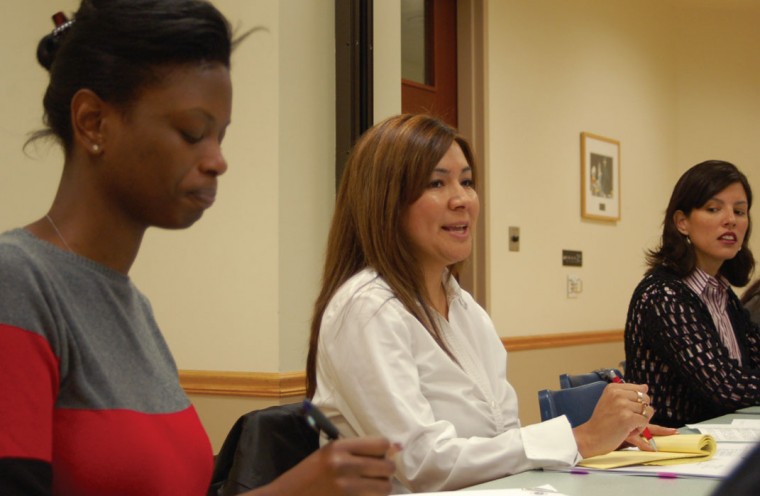 Interim Director Analia Mendez, center, speaks at a meeting with the advisory board on Friday in the Lobby Suite.: