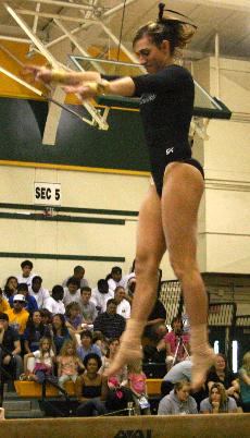 Senior Sara Williams performs on the beam during senior meet on Sunday. She scored a 9.5 during her exhibition routine.: