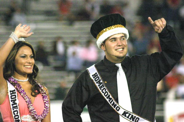 File photo: Homecoming queen Lindzie Navarrette, a senior criminal justice major, and Homecoming king Curtis Grima, a sophomore journalism major, wave to the crowd at halftime of the Sacramento State football game on Oct. 1, 2005.: