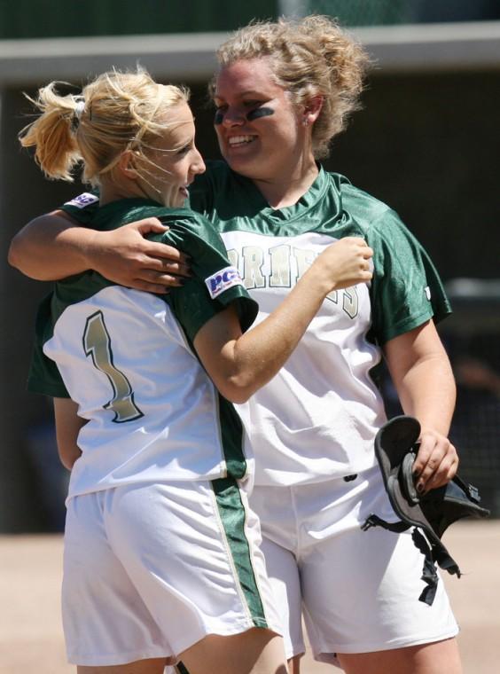 Junior Amy Tompkins, left, congratulates Sophomore Jamie Schloredt on hitting a walk off grand slam during Saturdays game against Saint Marys at Shea Stadium. The first game of the double header, the Hornets won both games, 2-1 and 5-1. :