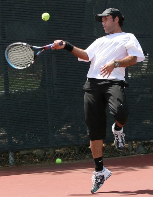 Ramon Perez contorts in order to return a shot during semifinal action Saturday.: