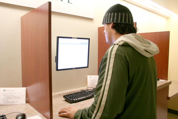 Junior kinesiology major Cameron Murray registers for classes at a terminal in Lassen Hall. :