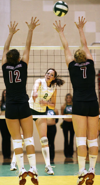 Hornet Missie Stidham spikes the ball past two Santa Clara players on Tuesday: