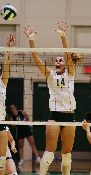 Senior Lindsay Haupt jumps up for the block against Nevada during the game on Tuesday night in the Hornets Nest.: