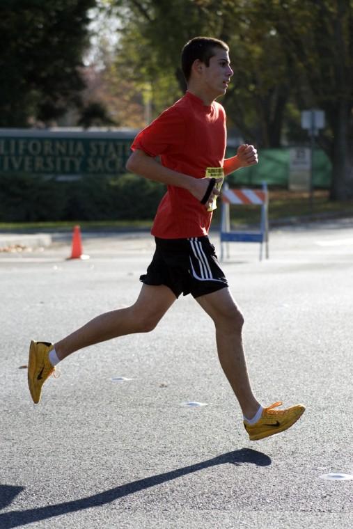 A runner passes by campus during Sunday's marathon.: