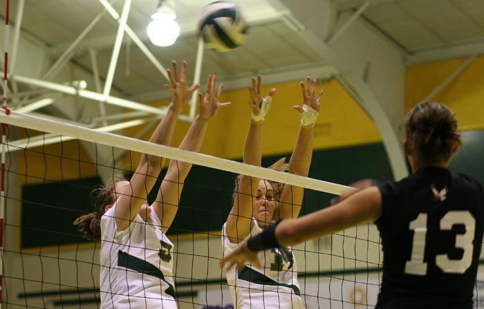 Sacramento State Rose Burke and Lindsay Haupt jump up to block the spike from Washington Eastern Hayley Hills during Fridays Big Sky Volleyball Tournament.: