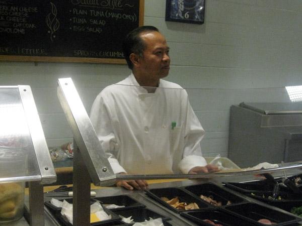 Production Manager Angel Balaoing at the Dining Commons deli station, ready to make sandwiches.: