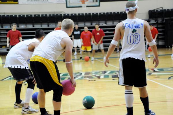 Dodgeball players await the next round at the Get Recd Night dodgeball tournament Tuesday night.: