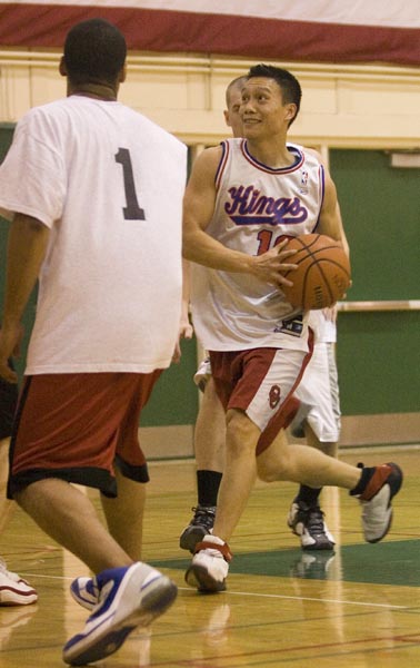 Junior Andy Dao, right, criminal justice major and member of team Ice Water, heads for the basket on Thursdays game against team Global. The game was held in the Hornets Nest.: