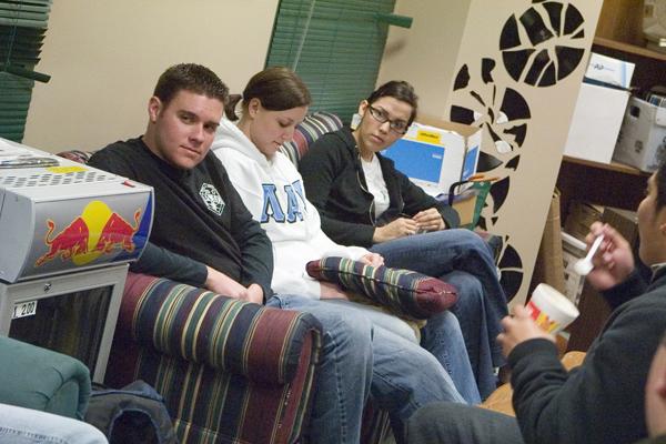 Senior Mike Severi, Desiree Dill, and senior Elizabeth Salinas sit on the couch talking to other members of their fraternity Lambda Alpha Epsilon-Sigma Chi. They wait in the KSSU Radio Station for calls to pick up those in need of a designated driver Saturday.: