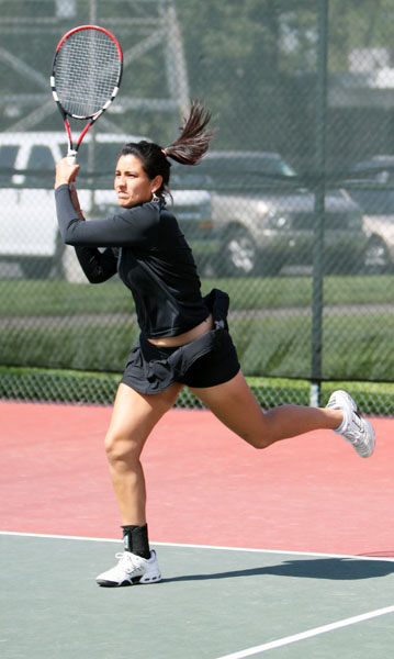 Freshman Melissa Valenzuela watches the ball fly during the 1:00 match on Thursday against Eastern Washington at Rio Del Oro Racquet Club.: