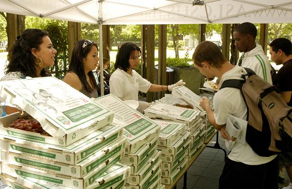 Laura Gonzalez, left, Patricia Mat, middle, and Maribel Rosendo, middle right, hand out free pizza after the ASI State of the Students Address.: