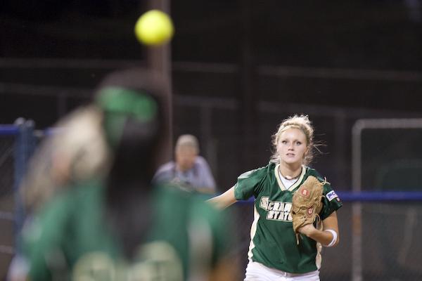 Third baseman Rachel Miles throwing to first base: