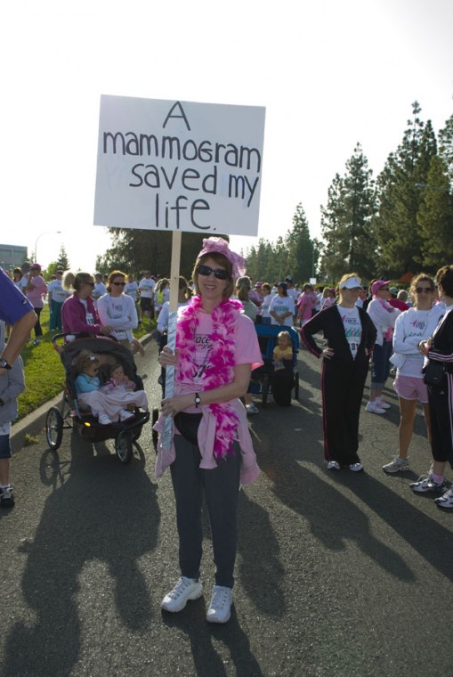 Candice Cohen, breast cancer survivor, holds up a sign before the walk.: