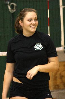Rose Burke laughs with her teammates during volleyball practice on Wednesday in the gym.: