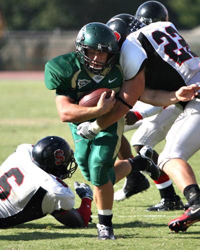 Sacramento State running back Jake Croxdale charges through the Southern Oregon defensive line leading to one of many Hornet first downs.: