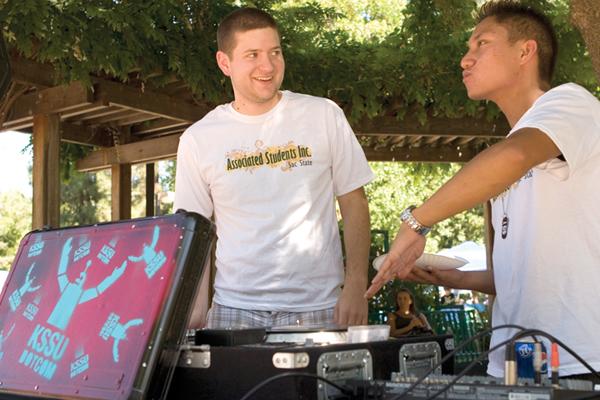 Junior Bobby Solorio and senior Jomer Belasario promote Sacramento States KSSU radio station in the Library Quad on Sept. 4, during the first week of school at the Associated Students Inc. Carnival. KSSU broadcasts 60 student DJs and streams online live.: