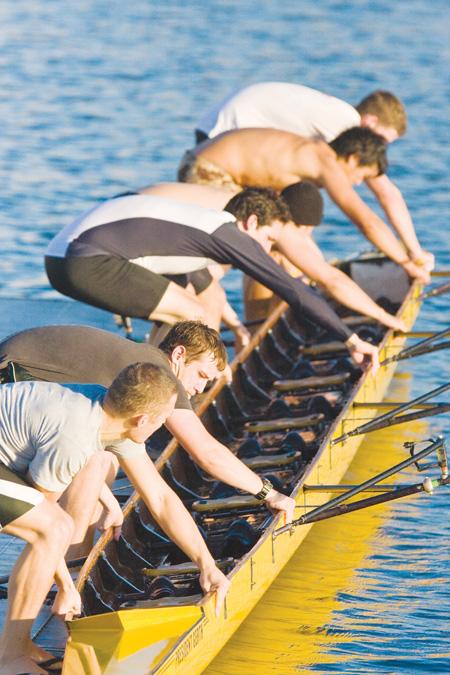 When the team is finished practicing, the rowers race to pull their boat out of the water and return it to the boat house. They compete against the other mens boats, as well as the plethora of women rowers who are getting out of the water: