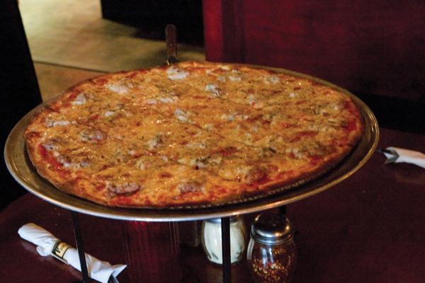 A thin-crust, Chicago-style pizza with sausage, shown above, is served at Chicago Fire located at 2416 J St. in Sacramento.:Claire Padgett