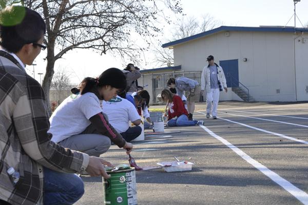 Sac State students paint the blacktop at the Jedediah Smith Elementary school as a part of the Alternative Break program.: